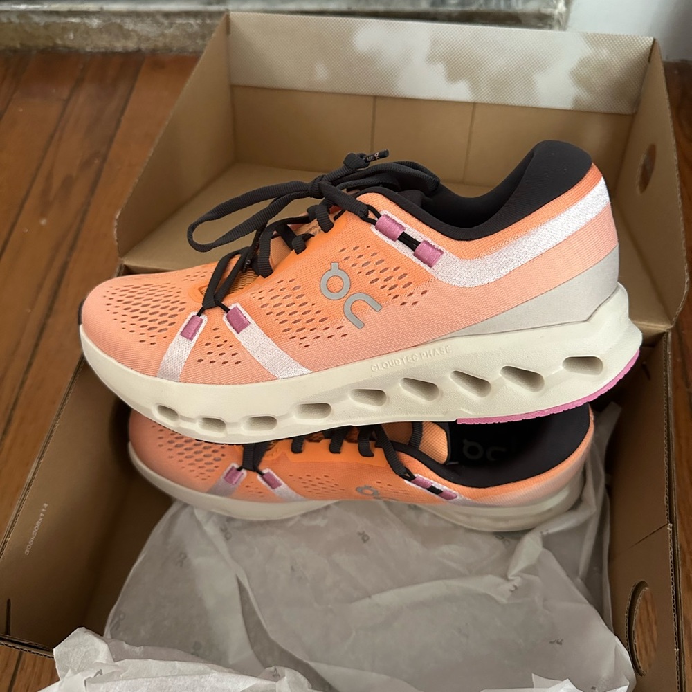 On Running Orange and Black Athletic Shoes with Modern Cushioning